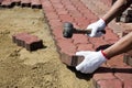 A worker laying concrete paving blocks. Royalty Free Stock Photo
