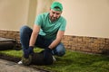 Worker laying grass sod on ground at backyard Royalty Free Stock Photo