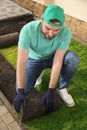 Worker laying grass sod on ground Royalty Free Stock Photo
