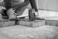 Worker laying new paving bricks or stones placing them in position Royalty Free Stock Photo