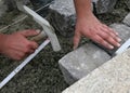 Worker laying paving stones
