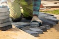A worker laying paving stones at a sidewalk construction site, close up Royalty Free Stock Photo