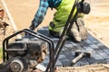A worker laying paving stones at a sidewalk construction site, close up Royalty Free Stock Photo