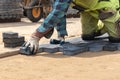 A worker laying paving stones at a sidewalk construction site, close up Royalty Free Stock Photo