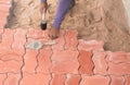 Worker laying red concrete paving blocks Royalty Free Stock Photo