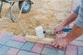 Worker laying red and gray concrete paving blocks. Road Paving, construction Royalty Free Stock Photo