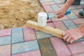 Worker laying red and gray concrete paving blocks. Road Paving, construction Royalty Free Stock Photo