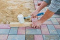 Worker laying red and gray concrete paving blocks. Road Paving, construction Royalty Free Stock Photo