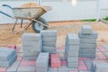 Worker laying red and gray concrete paving blocks. Road Paving, construction Royalty Free Stock Photo