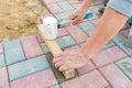 Worker laying red and gray concrete paving blocks. Road Paving, construction Royalty Free Stock Photo