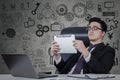 Worker leans on chair while using tablet Royalty Free Stock Photo