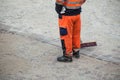 Worker legs on cobblestone maintenance site on main pl