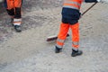 Worker legs on cobblestone maintenance site on main pl