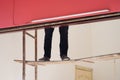 Worker legs on easy breakable ladder. Concept of painting worker and dangerous work Royalty Free Stock Photo