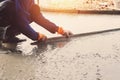 worker leveling concrete pavement for mix cement at construction Royalty Free Stock Photo