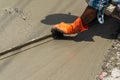 Worker leveling concrete pavement .spreading poured concrete on the road Royalty Free Stock Photo