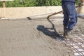 worker leveling fresh concrete slab with special working tool Royalty Free Stock Photo