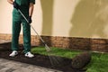 Worker leveling soil before laying grass sod at backyard, closeup Royalty Free Stock Photo