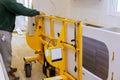 Worker lifting granite countertop with beautiful kitchen cabinet Royalty Free Stock Photo