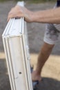 The worker lifts the PVC window with a suction cup for the windo