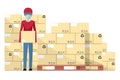Worker loading a box from a pallet with boxes stacked in warehouse for delivery. Industrial storage and distribution of products Royalty Free Stock Photo