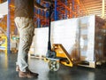 Worker loading cargo shipment pallet goods at warehouse storage. Royalty Free Stock Photo