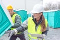 Worker loading portable toilets on truck