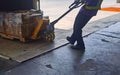 Worker loading and unloading shipment carton boxes and goods on wooden pallet by forklift from container truck to warehouse cargo