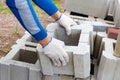 Worker loads cinder blocks from cement slurry for construction