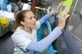 Worker loads laundry clothing into washing machine Royalty Free Stock Photo