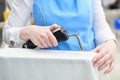 The worker loads the Laundry in the washing machine