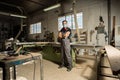 Worker looking at camera in a factory