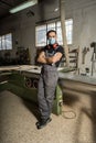 Worker looking at camera in a factory