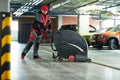 Worker with machine cleaning floor in parking garage. Royalty Free Stock Photo