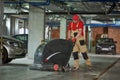 Worker with machine cleaning floor in parking garage. Royalty Free Stock Photo