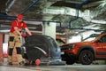 Worker with machine cleaning floor in parking garage.