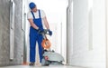 worker with machine cleaning floor in residence hall Royalty Free Stock Photo