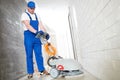 worker with machine cleaning floor in residence hall Royalty Free Stock Photo