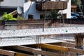 Worker maintains a descending concrete slab at a construction site