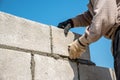 Worker make concrete wall by cement block and plaster at constru Royalty Free Stock Photo