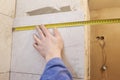 Worker makes repairs in the apartment. Measure tape and pencil in the hands of a builder. Dismantling the room. Closeup