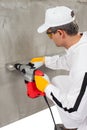 Worker making a hole through a lath