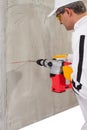 Worker making a hole with a perforator