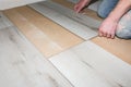 Worker making laminate flooring in apartment. Maintenance repair renovation. Wooden parquet planks indoors Royalty Free Stock Photo