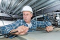 worker making mounting for electric cable in ceiling Royalty Free Stock Photo