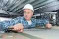 Worker making mounting for electric cable in ceiling Royalty Free Stock Photo