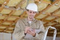 Worker making notes on clipboard during property renovation