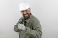 Worker man wearing hardhat screaming shouting anger rage with drill tool