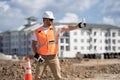 Worker man on the building construction. Construction site worker in helmet work outdoors. Builder worker working on Royalty Free Stock Photo