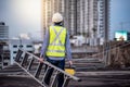 Worker man carrying aluminium ladder and tool box Royalty Free Stock Photo